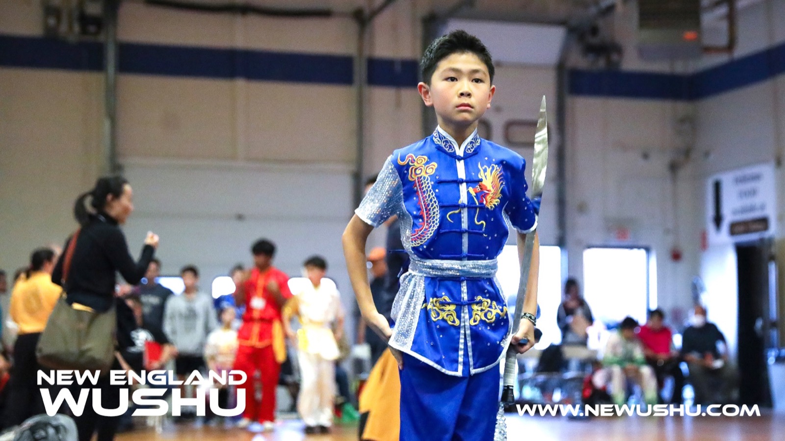 A New England Wushu athlete with a broadsword at a tournament