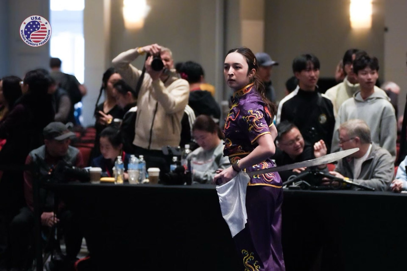An athlete performs in front of the judges' table