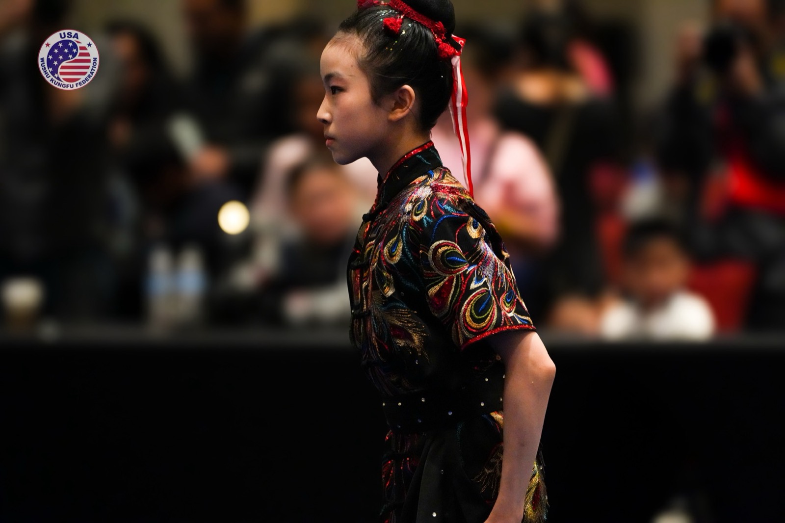 An athlete in a longfist uniform waits to compete